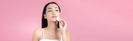 Girl remove makeup. Woman hand with pad. Skin clean with cotton.の写真素材