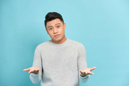 Young handsome man against a white background celebrating a victory or success, he is surprised and shocked.の写真素材