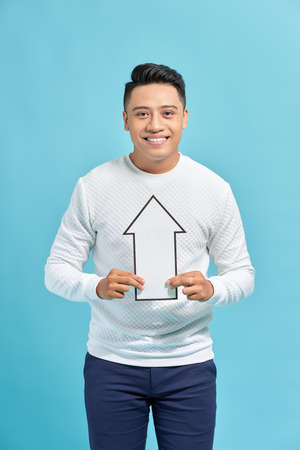 Smiling man holding white sign of arrow