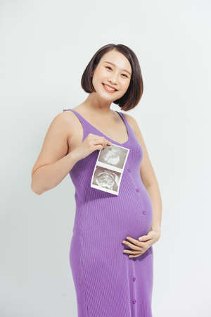 Pregnant women with film pictures,Asian pregnant woman show with ultrasound baby on white background