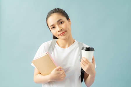 Displeased sleepy overworked girl drinks takeaway coffee, feels fatigue after learning material all...