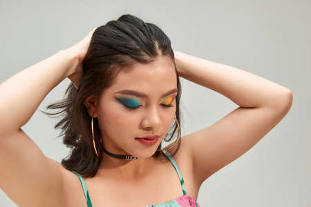 Beauty portrait of beautiful emotional asian girl with short hair on gray studio background.の写真素材