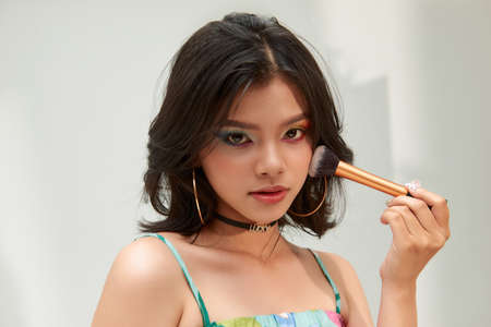 bright closeup portrait picture of beautiful woman with brushの写真素材