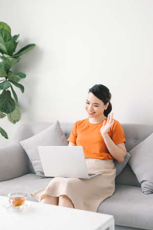 Happy girl chatting online on laptop