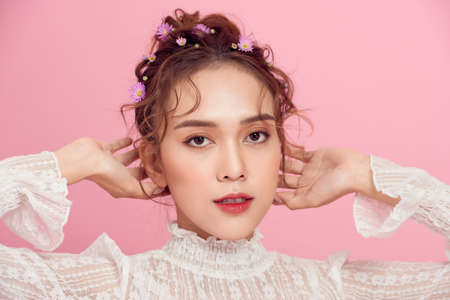 Beautiful young woman with flowers in her hair close-up portrait