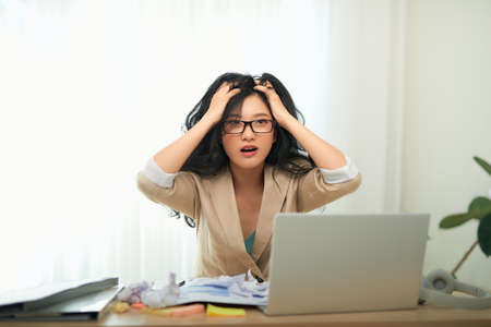 Businesswoman having head pain in office