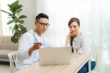 Male Obstetrician-gynecologist working with young stress woman in clinic or hospital healthcareの写真素材