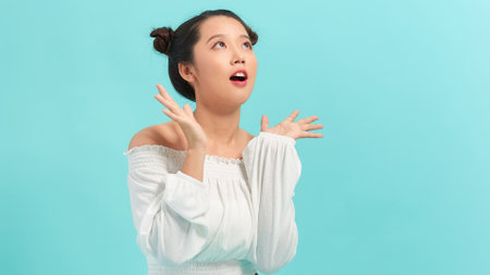 Close-up portrait of amused, surprised asian girl receive incredible good news, touch cheeks and...