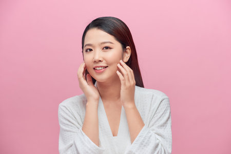 Female Skin Care. Young asian woman touching her faceの写真素材