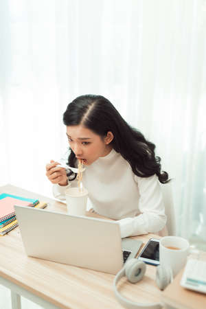 Young Asian girl sitting on desk work overtime, enjoy relax time.female working .