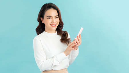 Portrait of beautiful woman using smartphone, isolated