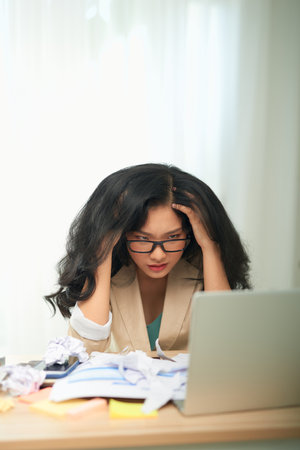 Businesswoman having head pain in office