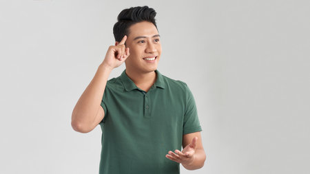 Young handsome man over blue background Smiling pointing to head with one finger, great idea or thought, good memoryの写真素材