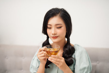 young attractive asian woman who drink teaの写真素材