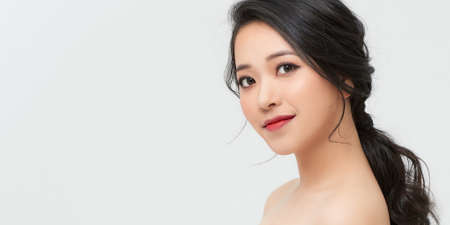 Beautiful smiling woman with clean skin, natural make-up on white background