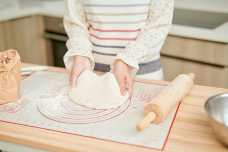 Woman kneading dough, close-up photoの写真素材