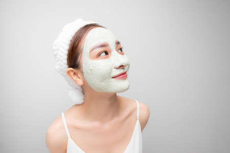 Attraactive young Asian woman with a face clay mask against acne on the face of a woman to...