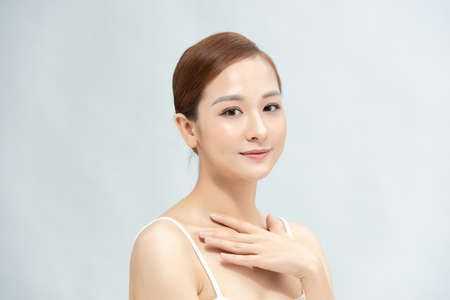 Beautiful beauty young female model girl touching her skinの写真素材