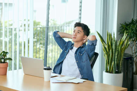 Happy smiling man working with laptopの写真素材