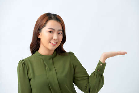 Young woman wearing casual clothes looking away to side with smile on face, natural expression....