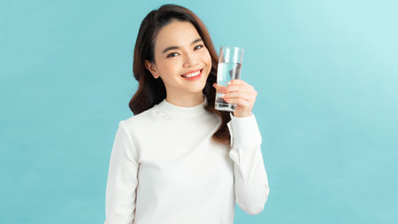 young asian woman with glass of waterの写真素材