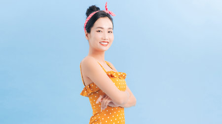 Beautiful woman in retro polka dot dress, surprised and admired by something. Pin up girl vintage.