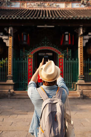 Asian man take a photo at the temple.の写真素材