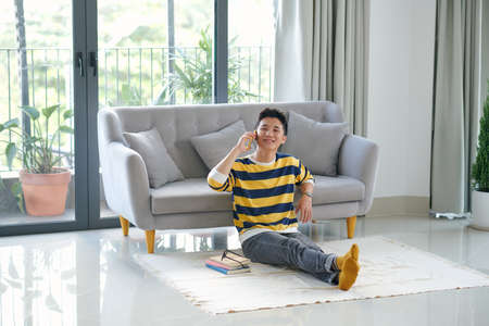 Smiling young man on the phone