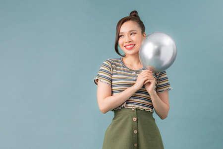 Woman hugging the Balloon on color backgroundの写真素材