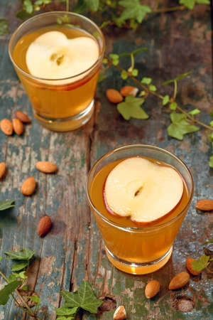 Hot drink of apple tea with cinnamon stick. Hot drink with apples for autumn or winter.