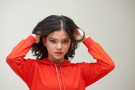 Portrait of woman with multicolored make-up over gray backgroundの写真素材