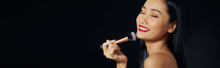 Beautiful woman is happy with makeup On a black backgroundの写真素材