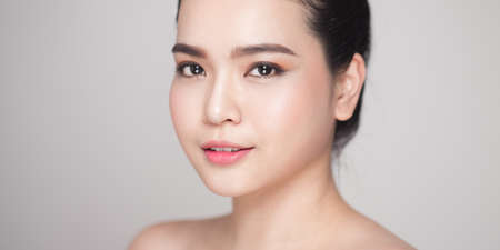 Beauty concept. Asian pretty woman with perfect skin looking at cameraの写真素材