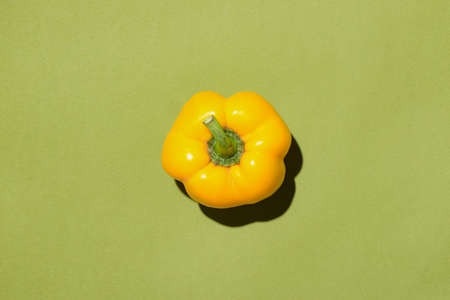 Top view of yellow bell pepper on green background.の写真素材