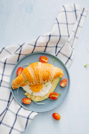 stuffed croissant with avocado, omelet egg and fresh vegetableの写真素材