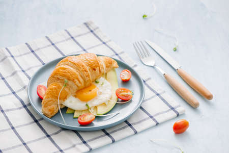 stuffed croissant with avocado, omelet egg and fresh vegetableの写真素材