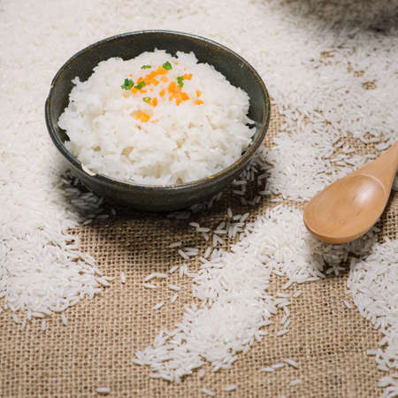 Close up of cooked rice in wooden in bowl on wooden tableの写真素材