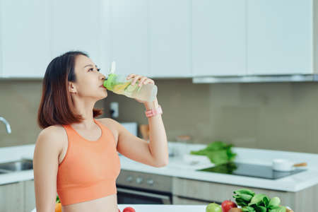 Detox Smoothie Diet Drink. Healthy Woman With Fit Body Drinking Fresh Organicの写真素材