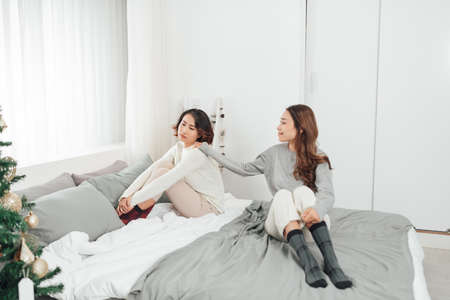 Beautiful LGBT gay lesbian couple together quarrel at home find out the relationshipの写真素材