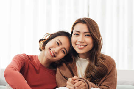 Happy young cute homosexual woman in bed room at homeの写真素材