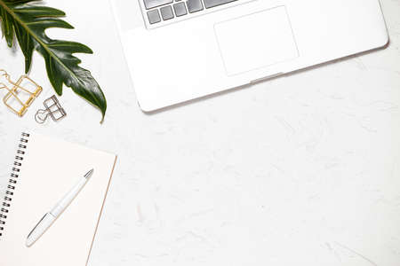 Top view office desk with keyboard, notebooks and coffee cup on marble background.の写真素材
