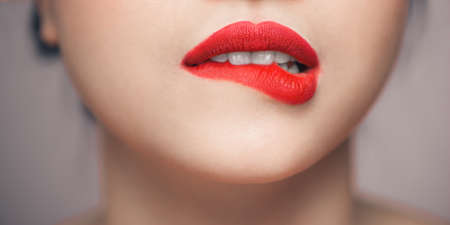 White Teeth Bit her lower Lip, Seductive Lips Redの写真素材