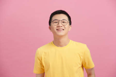 Attractive Asian man with glasses close up portraitの写真素材