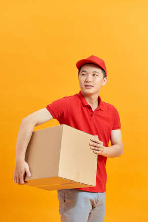 Mail man deliver package, shipping order from post man with red uniformの写真素材