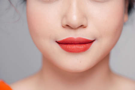 Beautiful curvy feminine lips with coral lipstickの写真素材