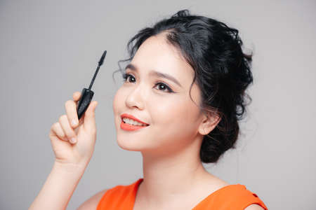Applying cosmetic make up eyelash Extensions. Asian eye make up cosmeticsの写真素材