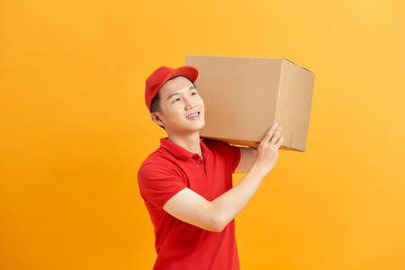 Delivery man holding parcel box isolated on white backgroundの写真素材