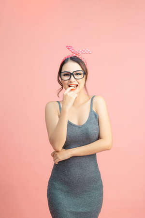 Portrait of positive pretty charming girl want meet popular guy feel shy isolated over pink backgroundの写真素材