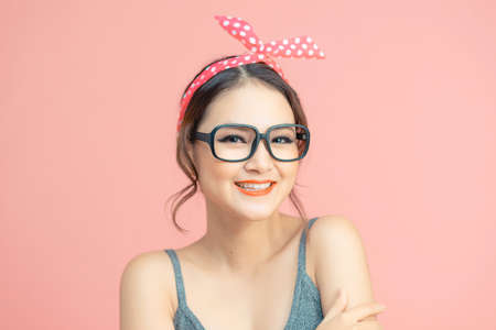 Portrait of lucky cute pretty woman enjoy summer free time holiday wear casual style clothes isolated over pink color backgroundの写真素材