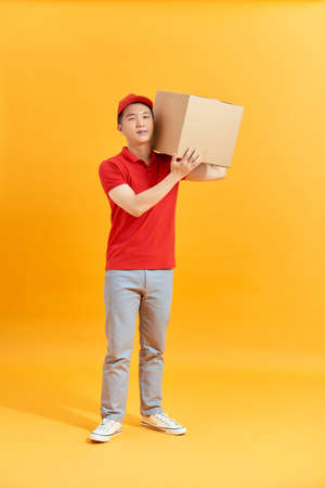 Delivery man holding parcel box isolated on white backgroundの写真素材